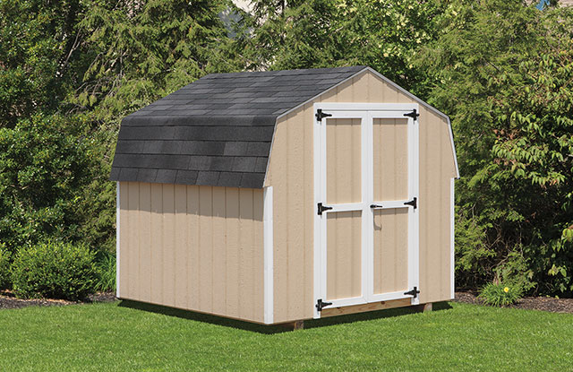 simple tan keystone storage shed in a small backyard