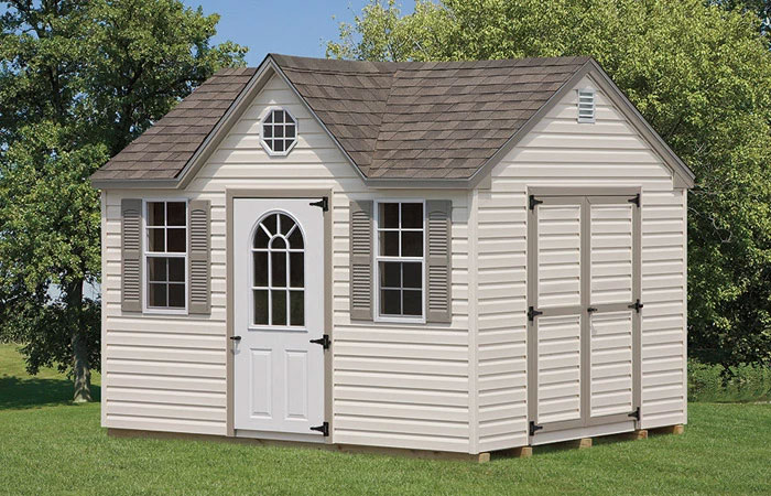 storage shed featuring beige trim and and pointed roof