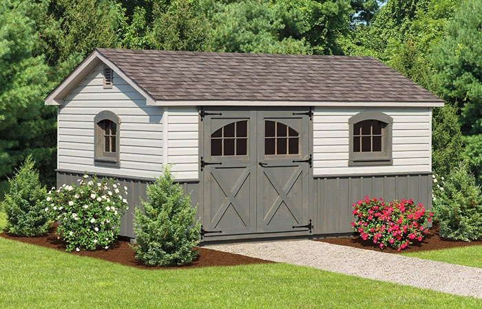 grey storage shed with decorative panel and asphalt roof