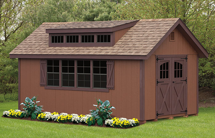 all brown dormer shed with large front windows