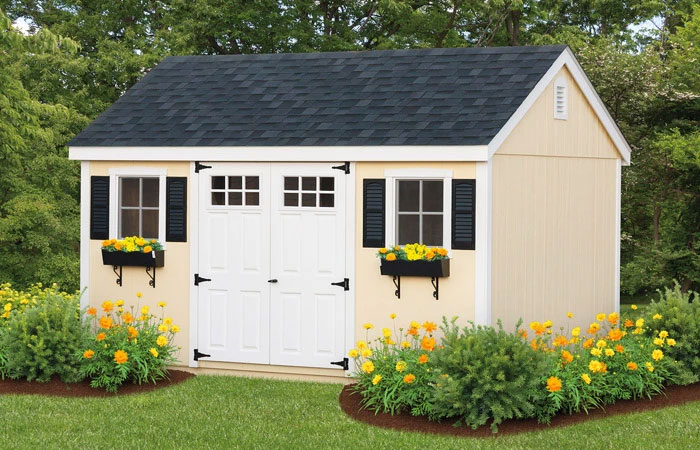 cream a frame shed with white doors and window boxes