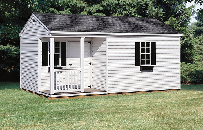 large white vinyl a frame storage shed with a small porch nook in the front