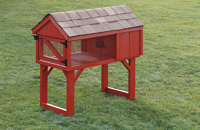 red elevated wooden rabbit hutch