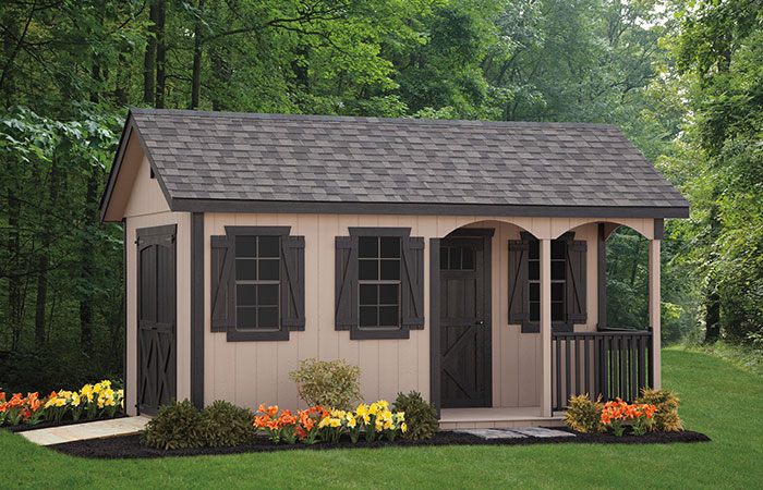storage shed with a small porch nook out front and workspace inside