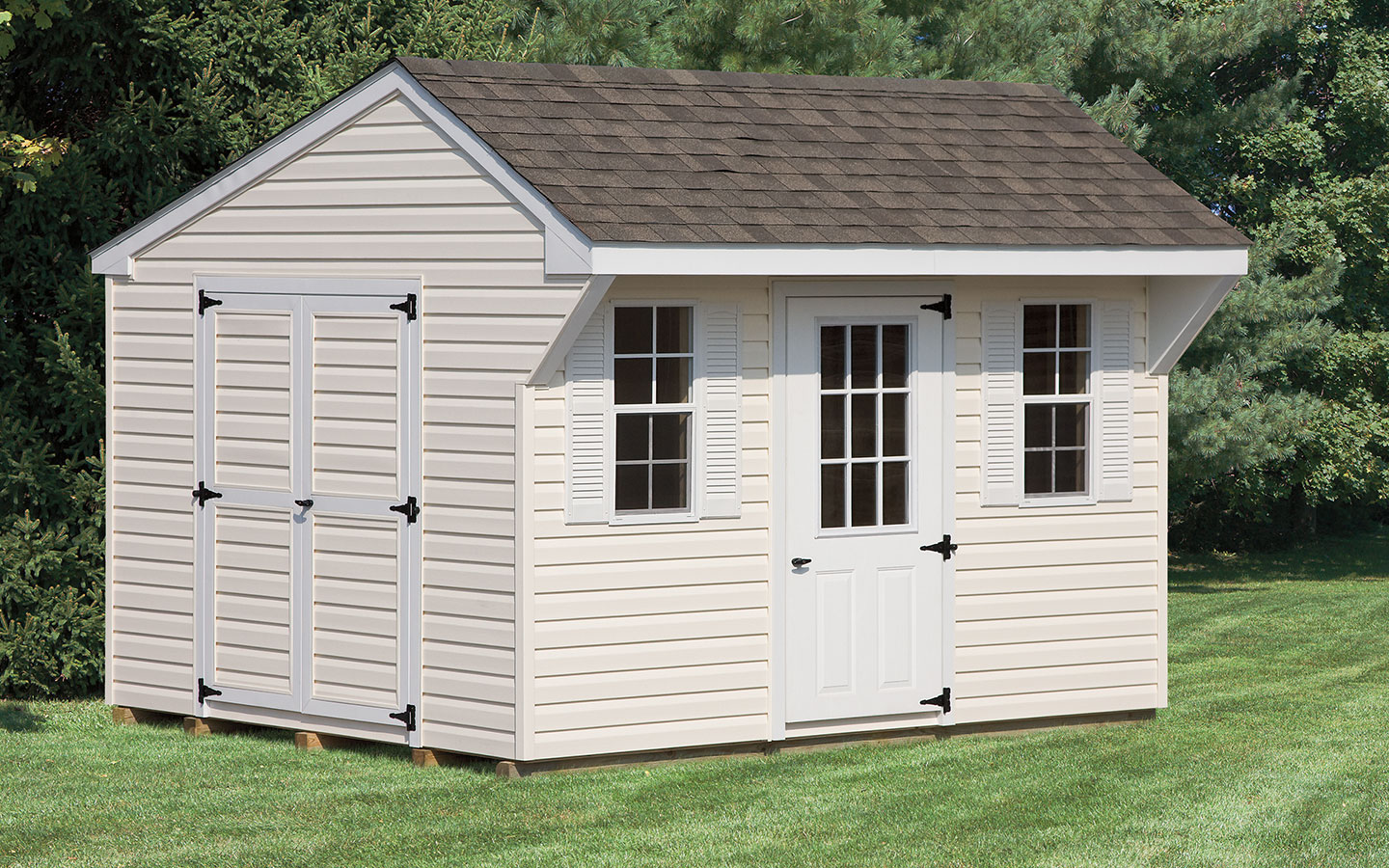 cream colored mini quaker style shed with overhang