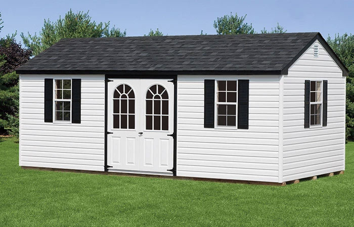 vinyl shed with white siding and black trim with deluxe doors