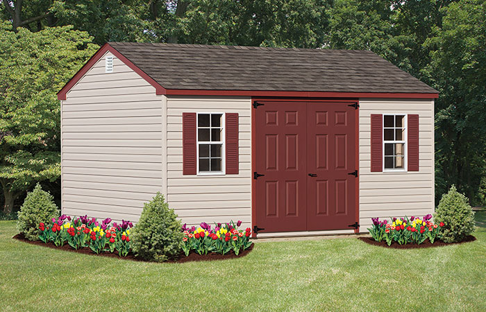 workshop style shed with red doors and red trim on the roof