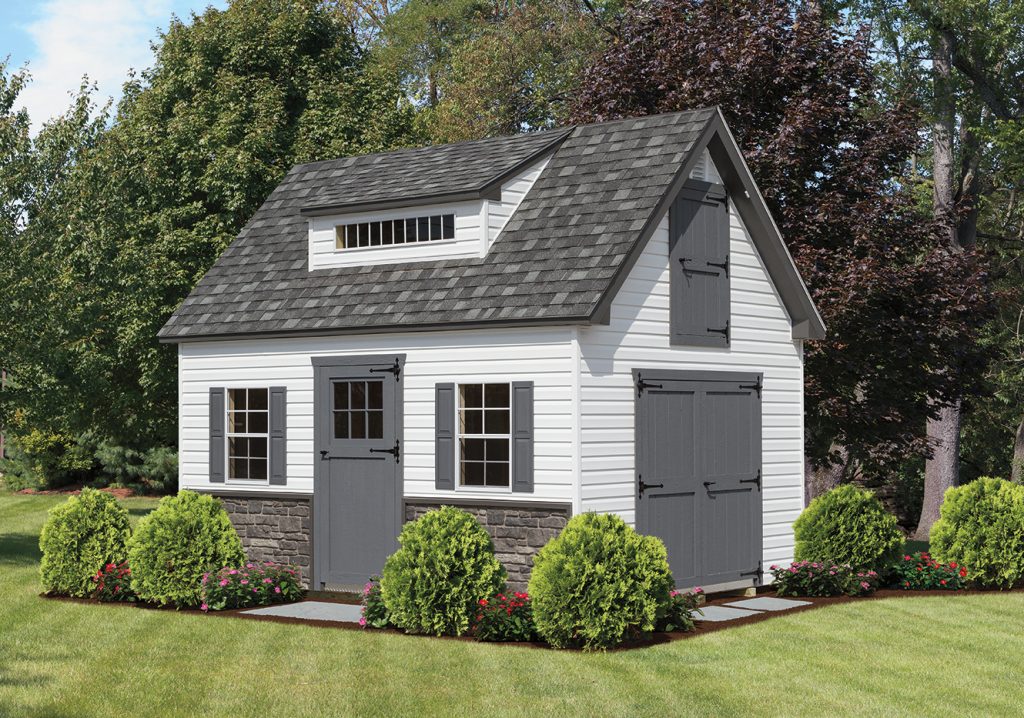 an a-frame shed with bushes in front